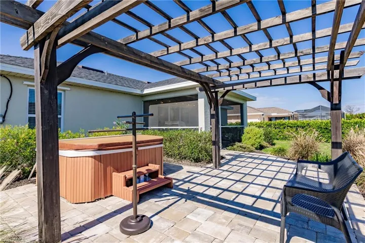 View of patio with a pergola and a hot tub