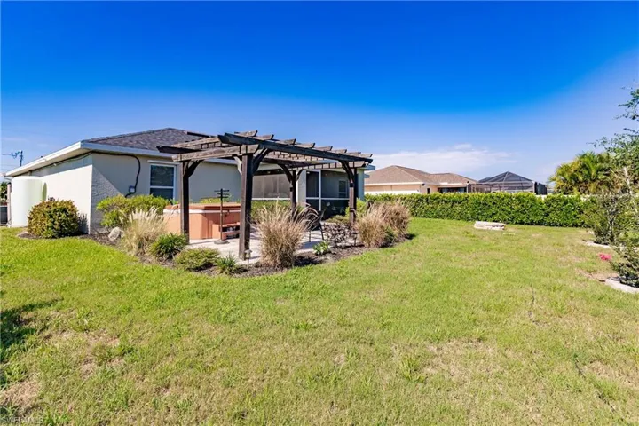 View of yard with a pergola and a patio area