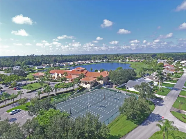 Birds eye view of property with a water view