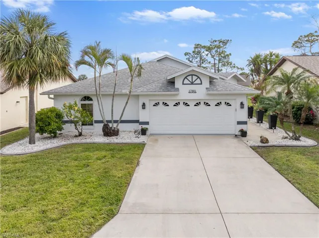 View of front of house featuring a front yard and a garage