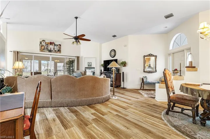 Living room featuring ceiling fan, plenty of natural light, and light hardwood / wood-style flooring