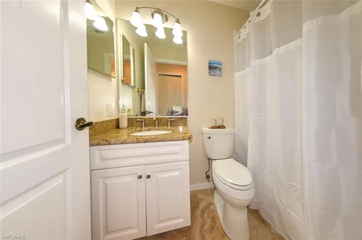 Bathroom featuring tile flooring, vanity, and toilet