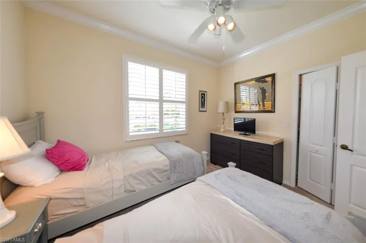 Bedroom with ornamental molding and ceiling fan