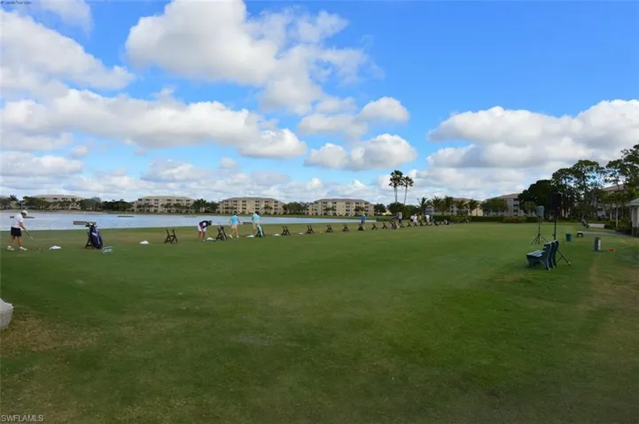 View of home's community with a lawn and a water view