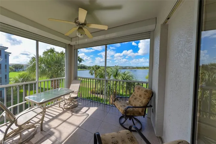 Sunroom / solarium featuring a water view and ceiling fan