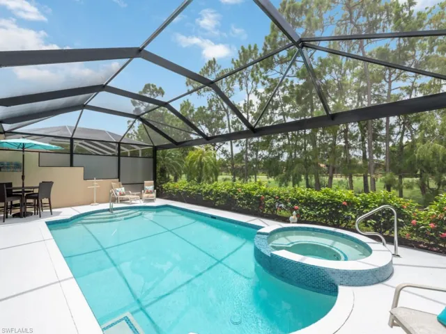 View of pool with an in ground hot tub, a patio, and a lanai