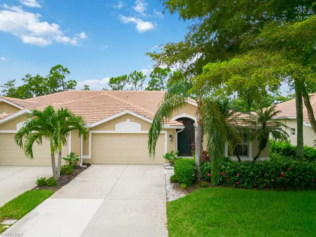 Single story home with a garage and a front yard