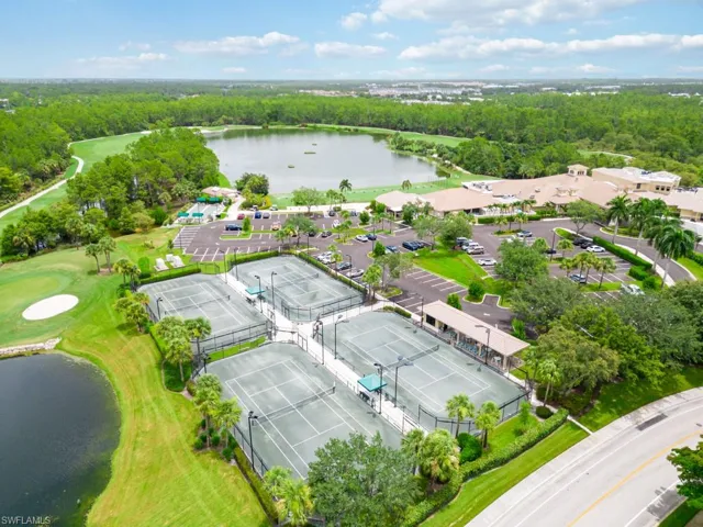 Birds eye view of property with a water view