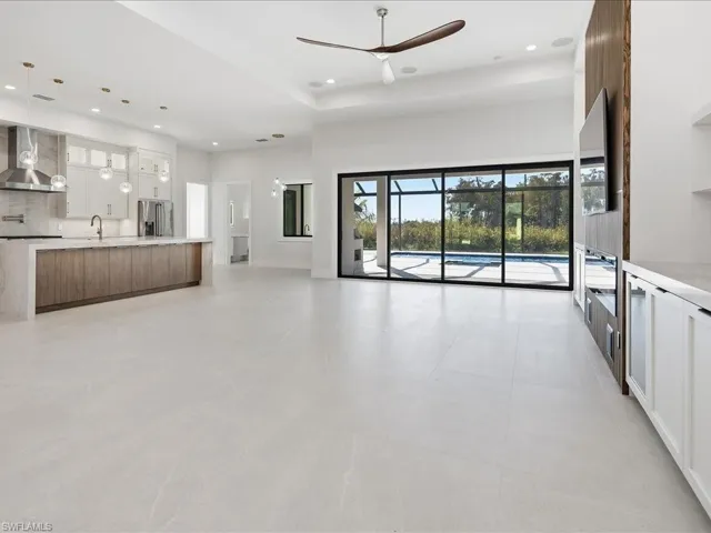 Unfurnished living room with a ceiling fan and recessed lighting