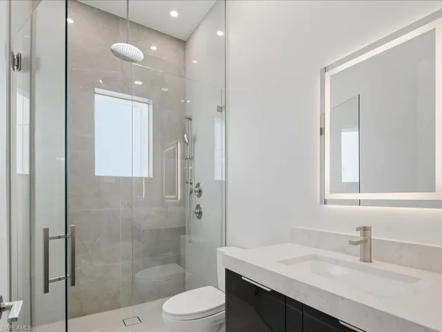 Bathroom featuring a stall shower and vanity