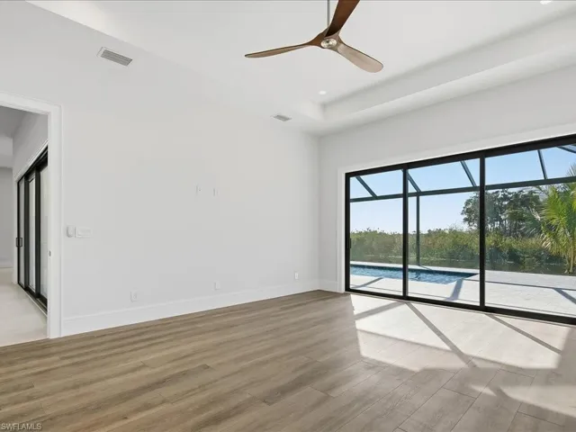 Unfurnished room featuring a sunroom, ceiling fan, light wood finished floors, and recessed lighting