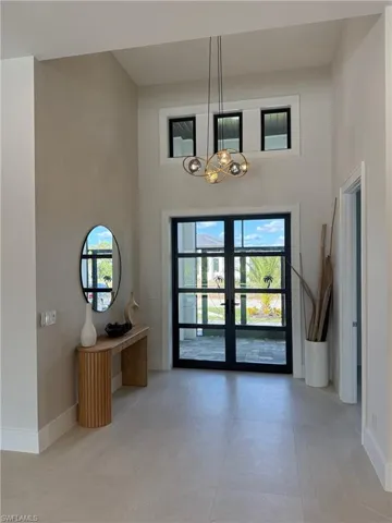 Entrance foyer featuring french doors and a towering ceiling