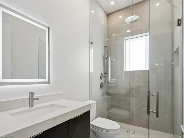 Full bath featuring a shower stall and vanity