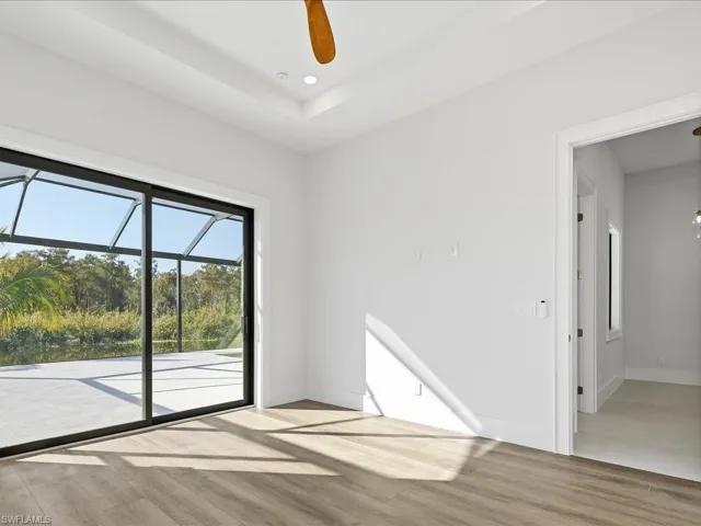 Empty room featuring ceiling fan, a sunroom, light wood-style flooring, and recessed lighting