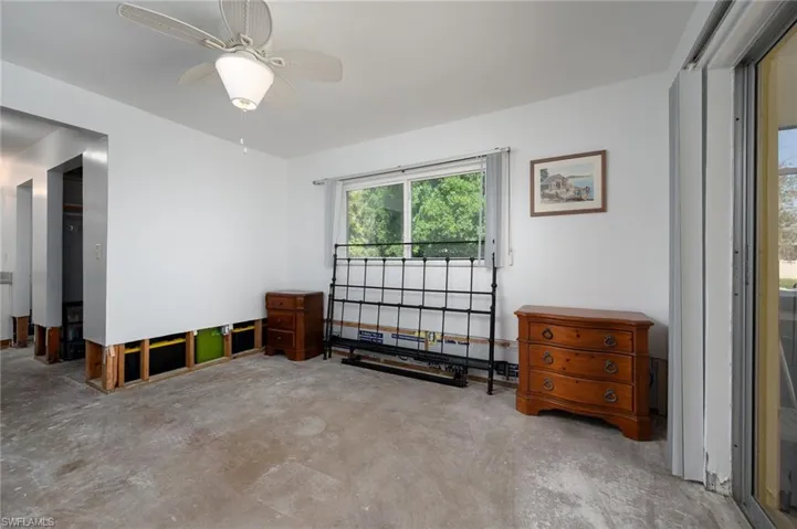 Primary bedroom with lots of closet space, concrete flooring, ceiling fan and ready for your finishing touches.