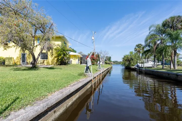 View from the boat lift of huge yard (1/2 acre) and a straight shot out to the Caloosahatchee River then Gulf.