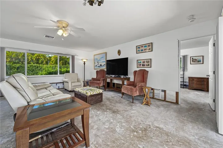 Living room from a different angle showing the picture windows and floor prepped for your new choice of flooring.