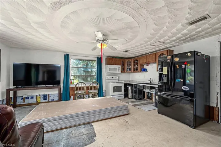 This is a 2nd Living area for extended family or guests with full kitchen and with ceiling fan, or could be a man-cave, movie room or family room - you pick!  Drywall has been purchased to complete the areas needed.