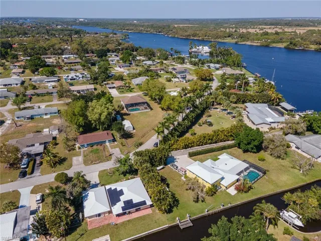 Birds eye view of property with a water view and a residential view