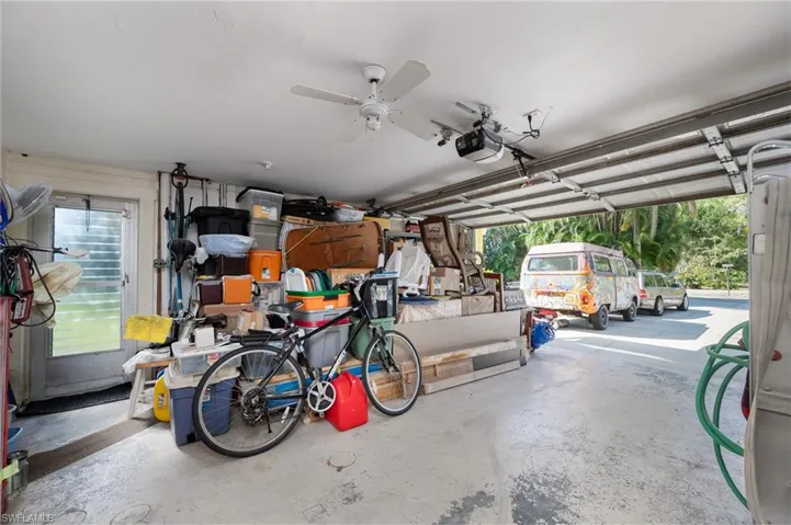 One of the 2 car Garages with a separate entrance into the 2nd living room and upstairs.  Garage also has a ceiling fan, garage door opener and a 2nd washer and dryer (behind the items).