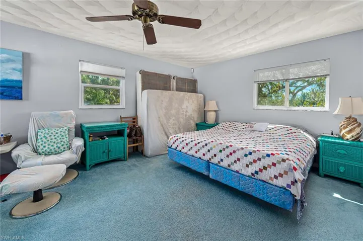 Carpeted 3rd bedroom featuring ceiling fan