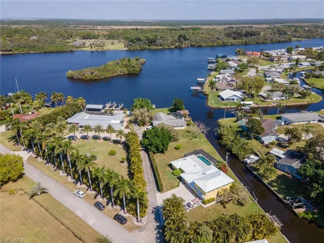 Birds eye view of property with a riverfront water view and a residential view
