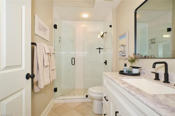 Bathroom featuring vanity, a stall shower, and light tile patterned floors