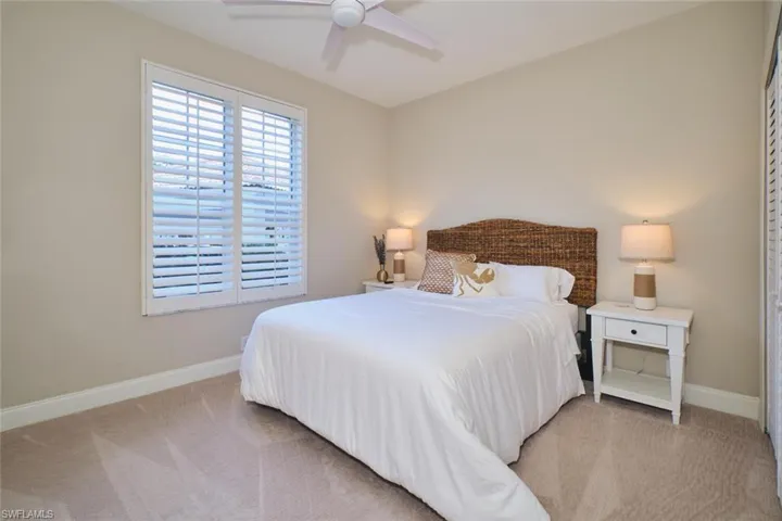 Bedroom featuring light colored carpet and ceiling fan