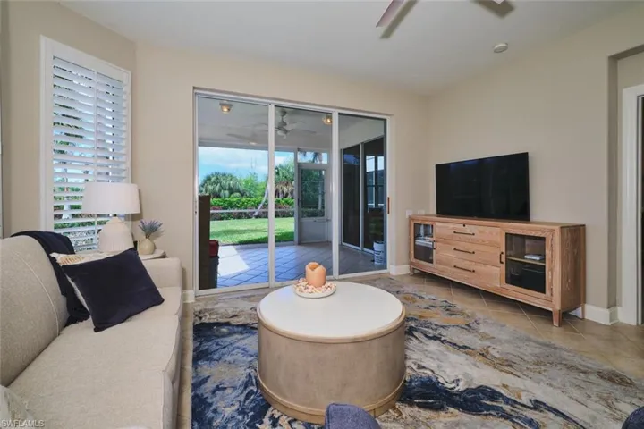 Living area with a ceiling fan and tile patterned floors