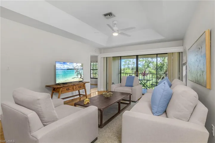 Living room is beautifully appointed with modern updated chairs and couch