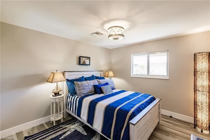 Guest bedroom with recessed lighting, tiled flooring