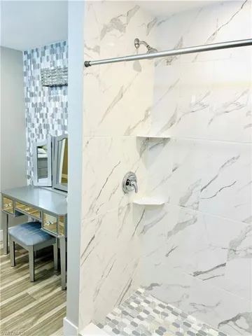 Marble-style walk-in shower, vanity area
