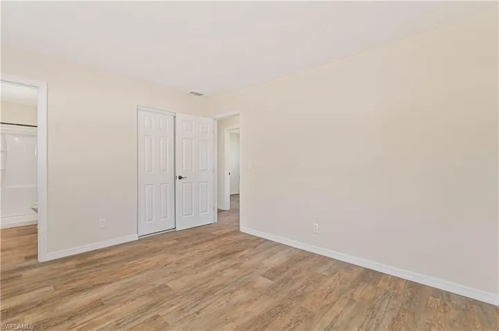 Unfurnished bedroom with light wood finished floors, baseboards, and a closet