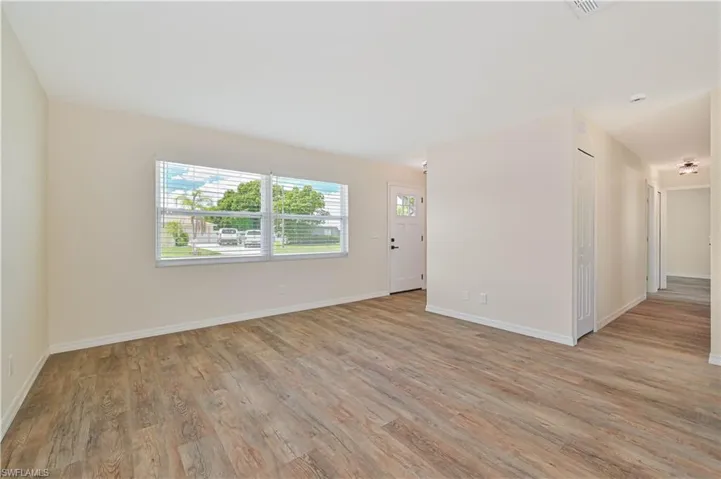 Spare room with light wood-style floors and baseboards