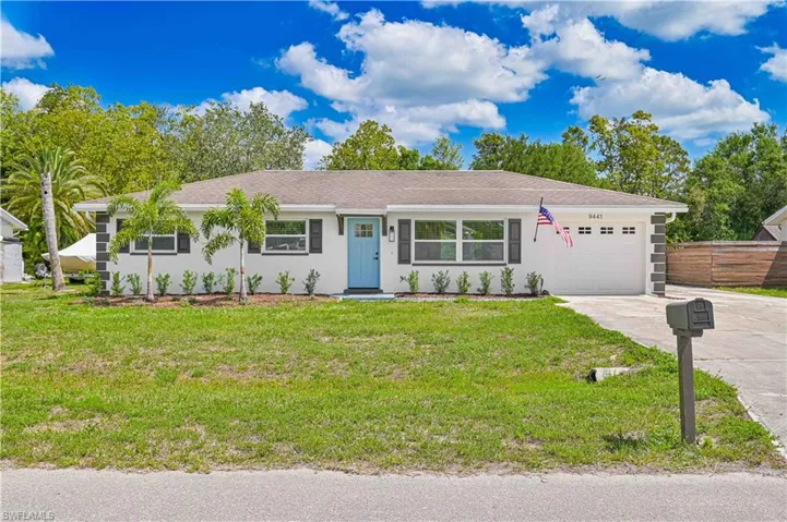 Single story home with an attached garage, driveway, and stucco siding