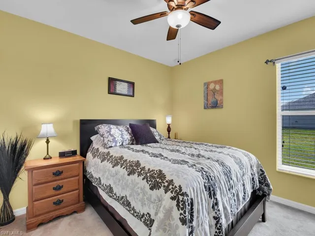 Carpeted bedroom with ceiling fan