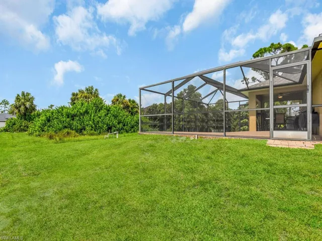 View of yard featuring glass enclosure