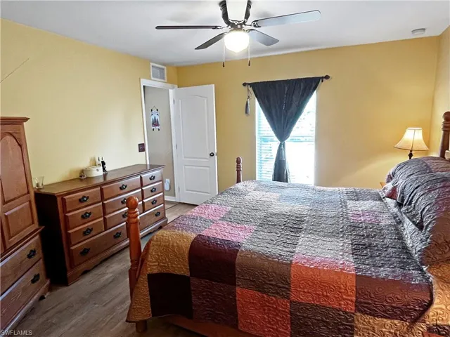Bedroom featuring ceiling fan and hardwood / wood-style floors