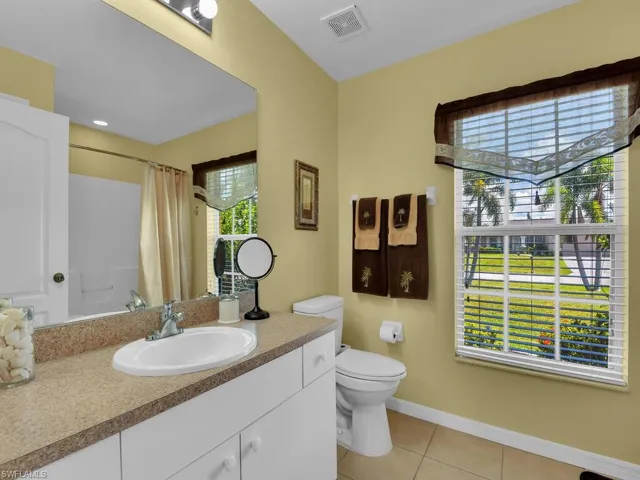 Bathroom with tile flooring, toilet, and vanity