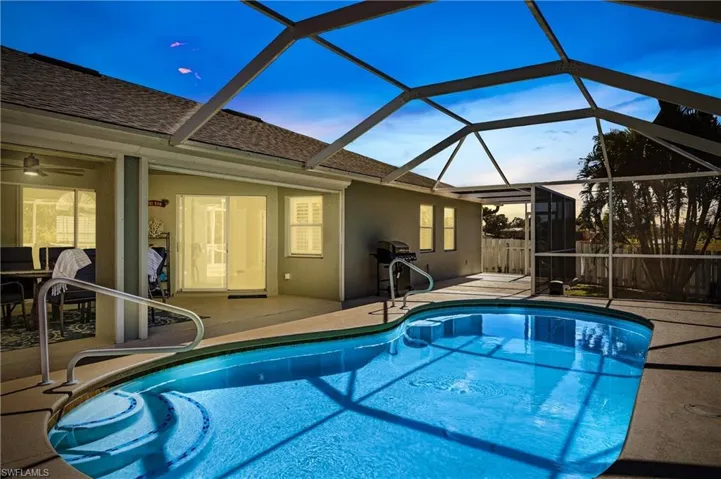 Outdoor pool featuring a patio area, a sunroom, and a lanai