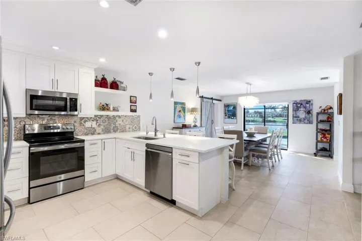 Recently renovated kitchen features shaker cabinets, quartz countertops and stainless appliances.