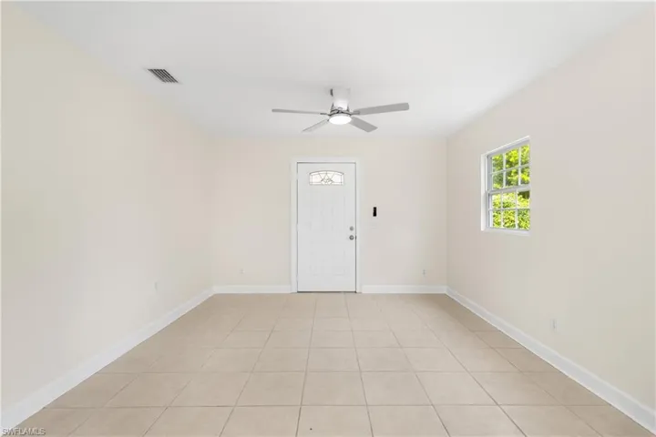 Spare room with light tile patterned floors and ceiling fan