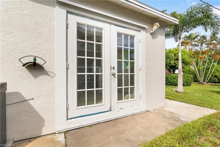 Doorway to property with french doors and stucco siding
