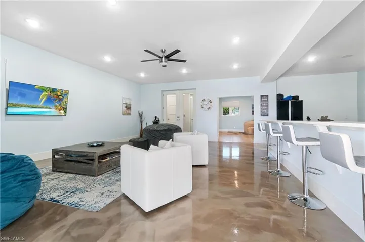 Downstairs living room with metallic epoxy floors