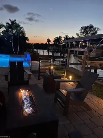 Patio terrace at dusk featuring an outdoor fire pit