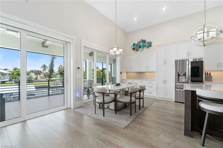 Dining space featuring high vaulted ceiling and an inviting chandelier