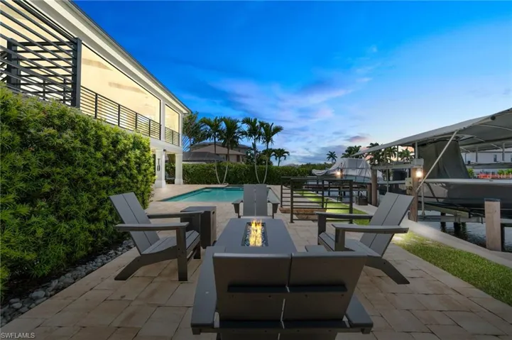 View of patio / terrace featuring an outdoor living space with a fire pit and a dock