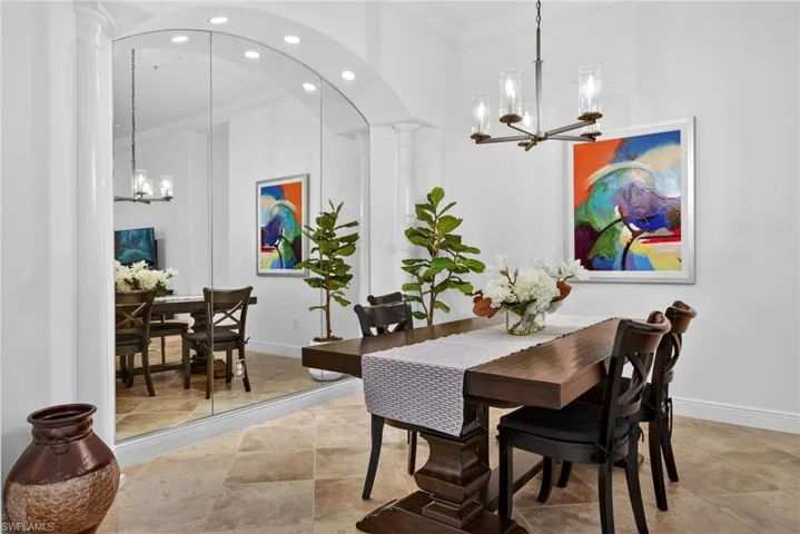Dining space with a chandelier, ornamental molding, and recessed lighting