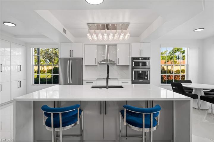 Light and bright condo has fabulous views of the lake and open space! Quartz waterfall island with storage.   French drawer refrigerator, backsplash, farm sink!