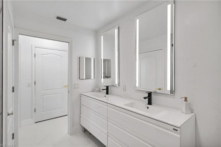 Master ensuite bath has comfort height dual vanities, backlit mirrors.